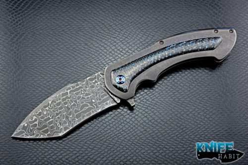 custom rick barrett full size fallout knife, stainless damascus blade steel, tumbled stonewashed titanium frame, blue mylar light strike carbon fiber inlays, timascus clip, blue anodized hardware