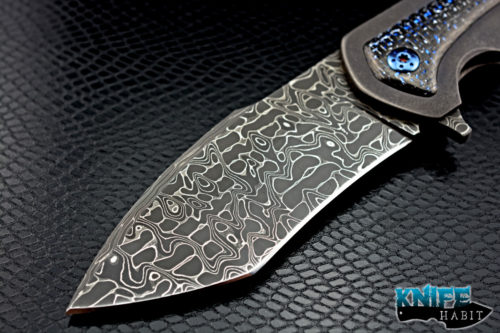 custom rick barrett full size fallout knife, stainless damascus blade steel, tumbled stonewashed titanium frame, blue mylar light strike carbon fiber inlays, timascus clip, blue anodized hardware