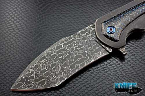 custom rick barrett full size fallout knife, stainless damascus blade steel, tumbled stonewashed titanium frame, blue mylar light strike carbon fiber inlays, timascus clip, blue anodized hardware