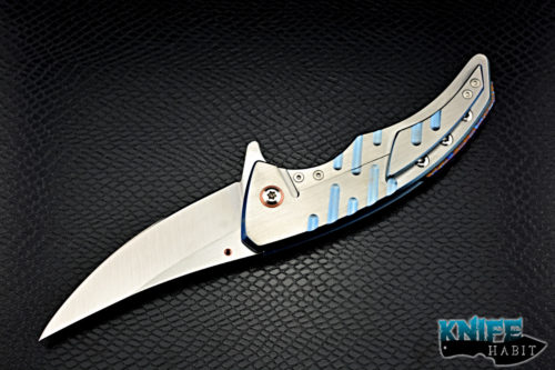 custom sergey rogovets model 19 knife, blue anodized milled titanium frame, cts-xhp blade steel, satin finish, mokuti backspacer, copper pivot collar and inlay