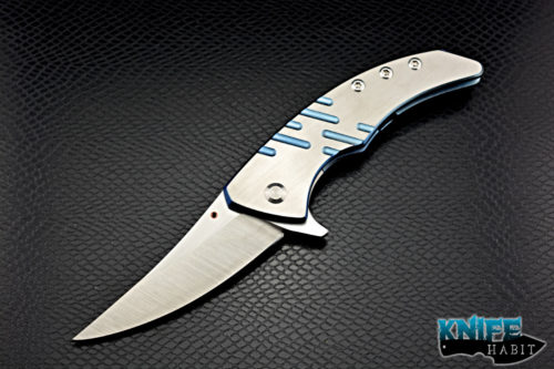 custom sergey rogovets model 19 knife, blue anodized milled titanium frame, cts-xhp blade steel, satin finish, mokuti backspacer, copper pivot collar and inlay