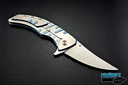 custom sergey rogovets model 19 knife, blue anodized milled titanium frame, cts-xhp blade steel, satin finish, mokuti backspacer, copper pivot collar and inlay