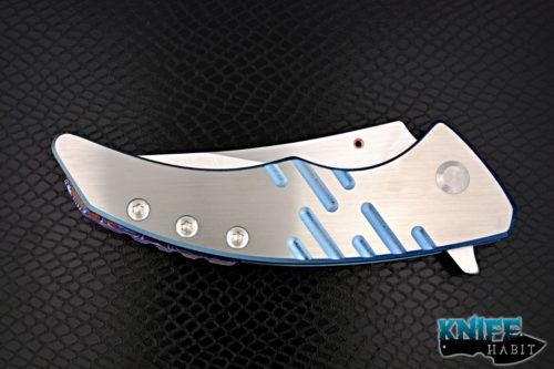 custom sergey rogovets model 19 knife, blue anodized milled titanium frame, cts-xhp blade steel, satin finish, mokuti backspacer, copper pivot collar and inlay