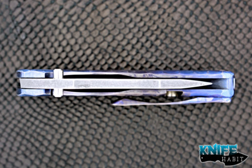 custom damjan eror small saurus knife, blue purple anodized sculpted titanium handle, aside washed 3v blade steel