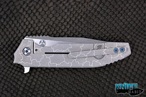 custom peter rassenti snafu integral knife, dual tone triple grind blade, desert floor titanium milled handle, blue hardware