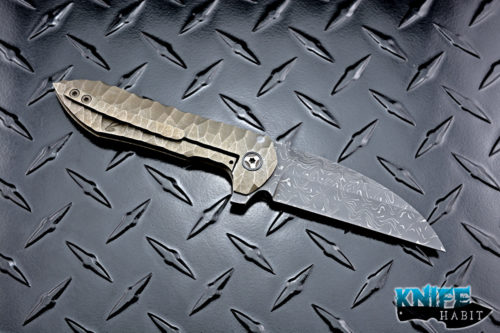 custom peter rassenti druid flipper knife, sculpted bronzed titanium integral frame, zirconium pivot collars, damascus blade