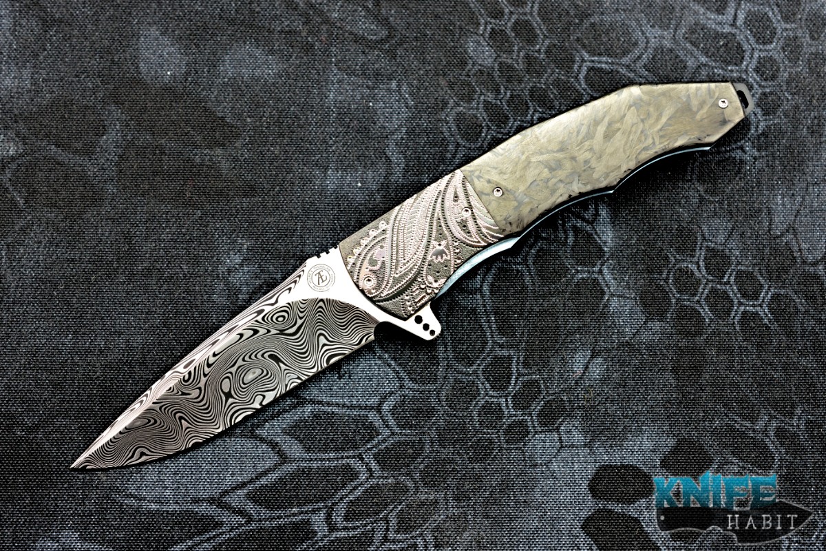 https://knifehabit.com/wp-content/uploads/2018/05/andre-thorburn-l53-damasteel-engraved-zirconium-marbled-carbon-fiber-custom-knife-01.jpg